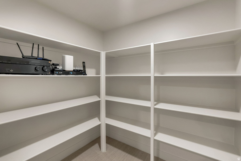 Corner pantry with extensive white shelving, providing ample storage capacity