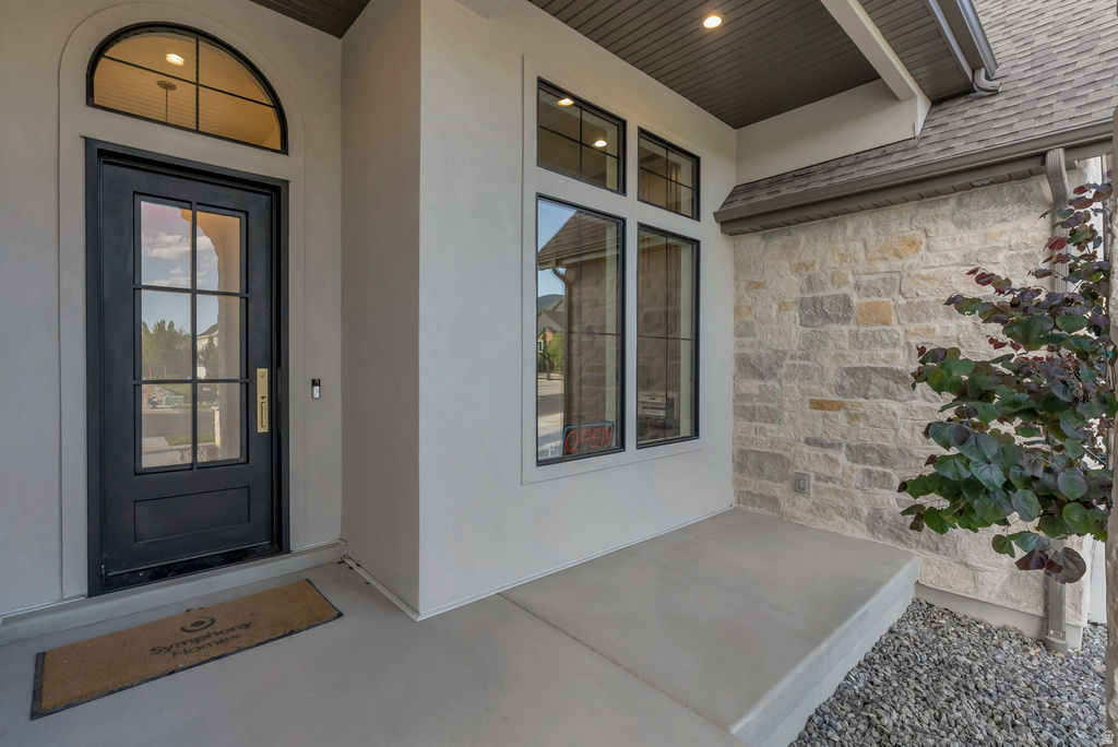 Entry featuring a black paneled door with glass inserts and an arched transom window