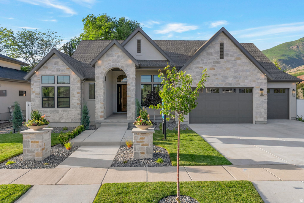 Stone and stucco exterior with a prominent arched entry