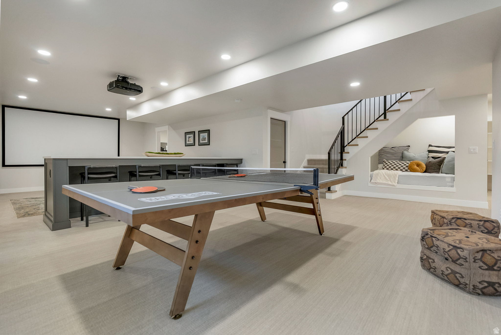 Spacious recreational area featuring light wood-finish flooring