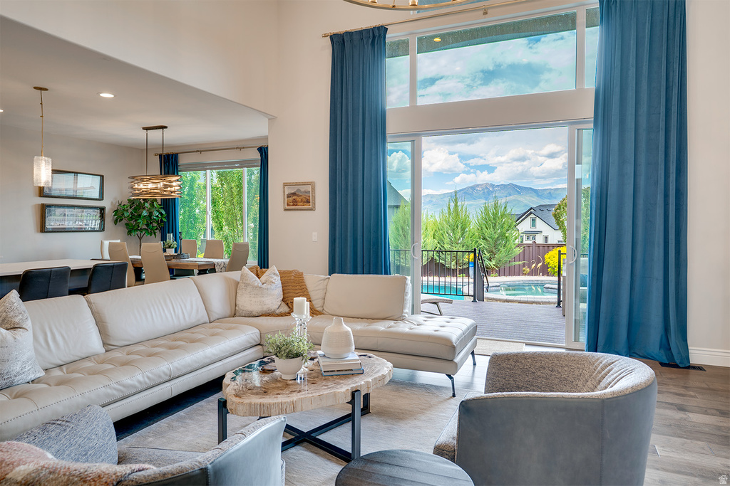 Spacious living area featuring high ceilings, wood-finish flooring, and expansive sliding glass doors