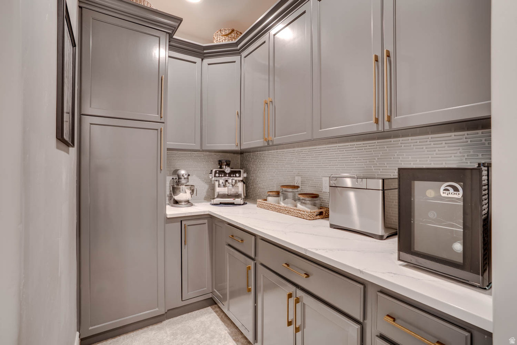 Built-in pantry cabinetry with crown molding and gold-tone hardware