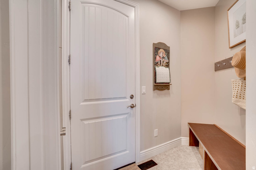 White paneled door with an arched top, featuring chrome hardware