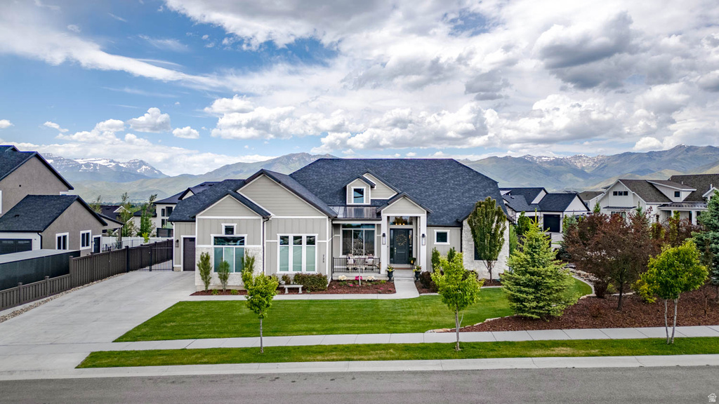 Modern ranch-style residence featuring a gray and white exterior with a dark shingle roof
