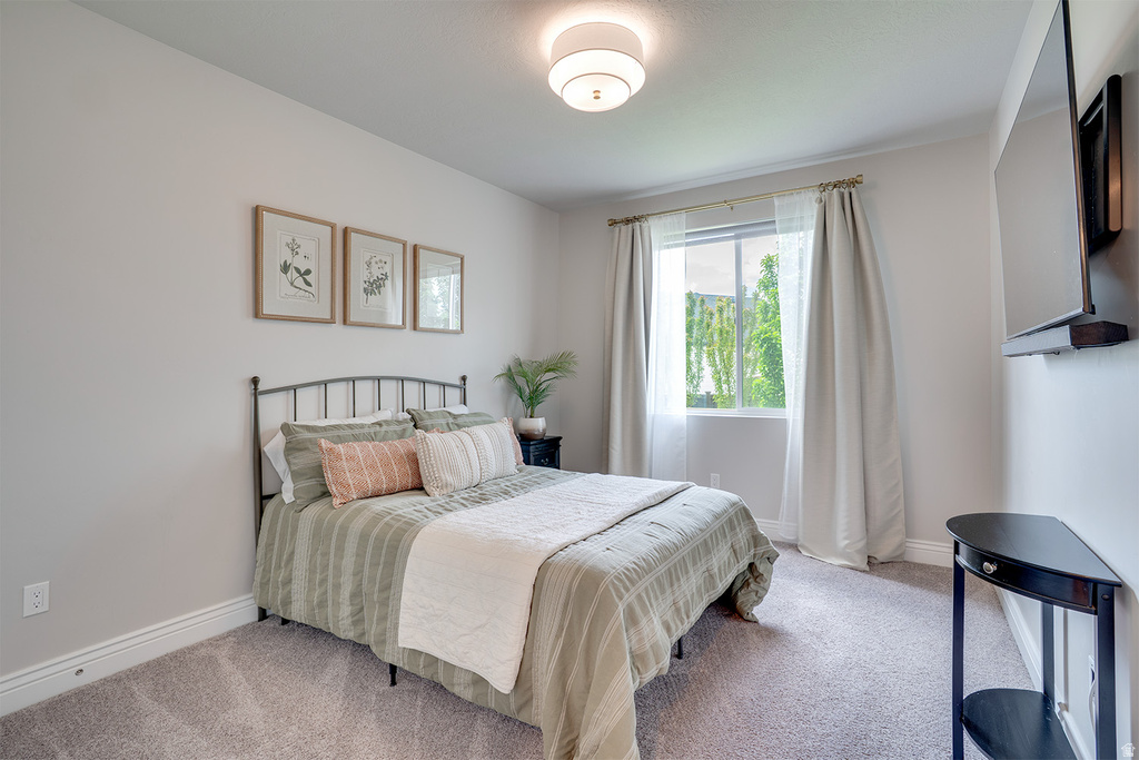 Bedroom featuring neutral wall colors and soft carpeting