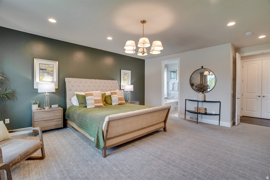 Spacious room with recessed lighting and a central chandelier