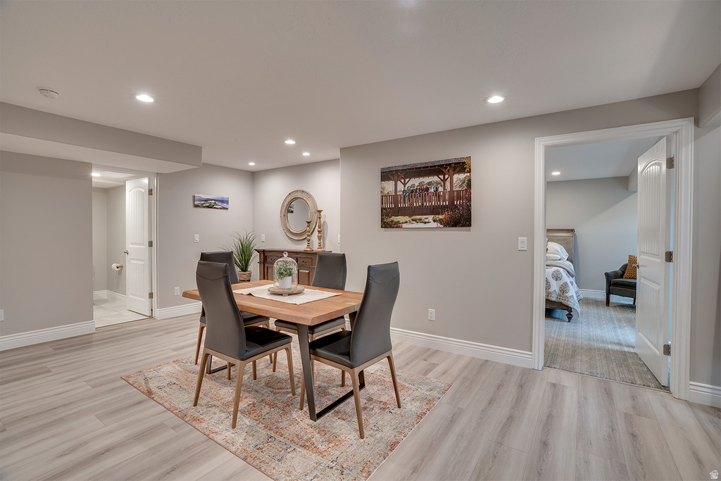 Open-concept room featuring light wood-finish flooring, recessed lighting, and crisp white baseboards