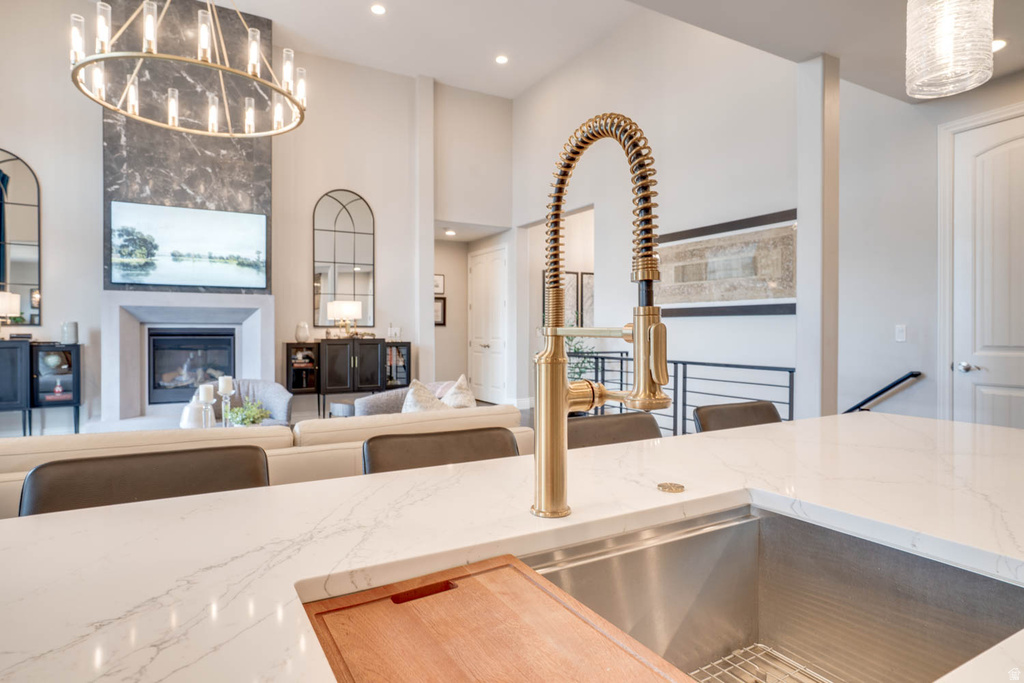 Kitchen island with a gold-finish gooseneck faucet, an undermount stainless steel sink, and light-toned quartz countertops