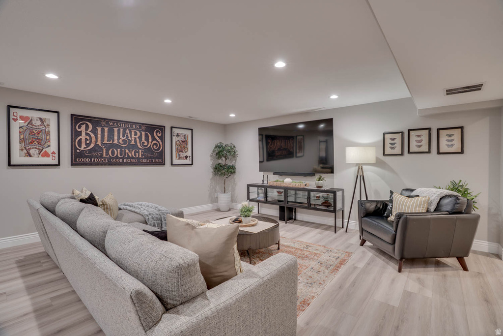 Finished living space featuring recessed lighting, wood-finish flooring, and light gray wall tones