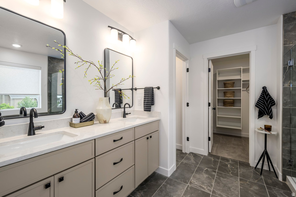 Dual vanity with matte black fixtures, light-toned cabinetry, and white countertops
