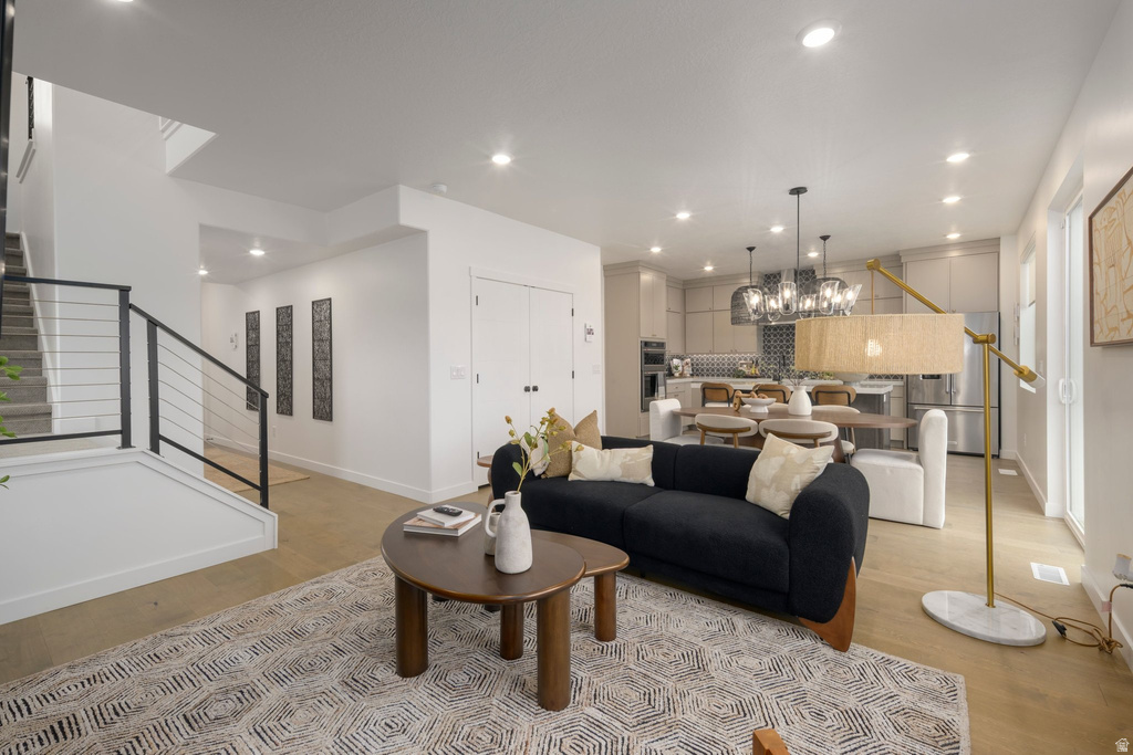 Open-concept living space featuring wood-finish flooring and recessed lighting