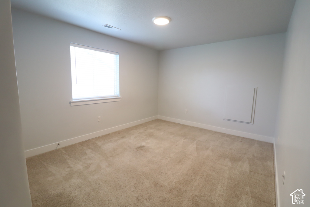 Neutral tone wall paint, flush mount ceiling lighting, and window with white blinds