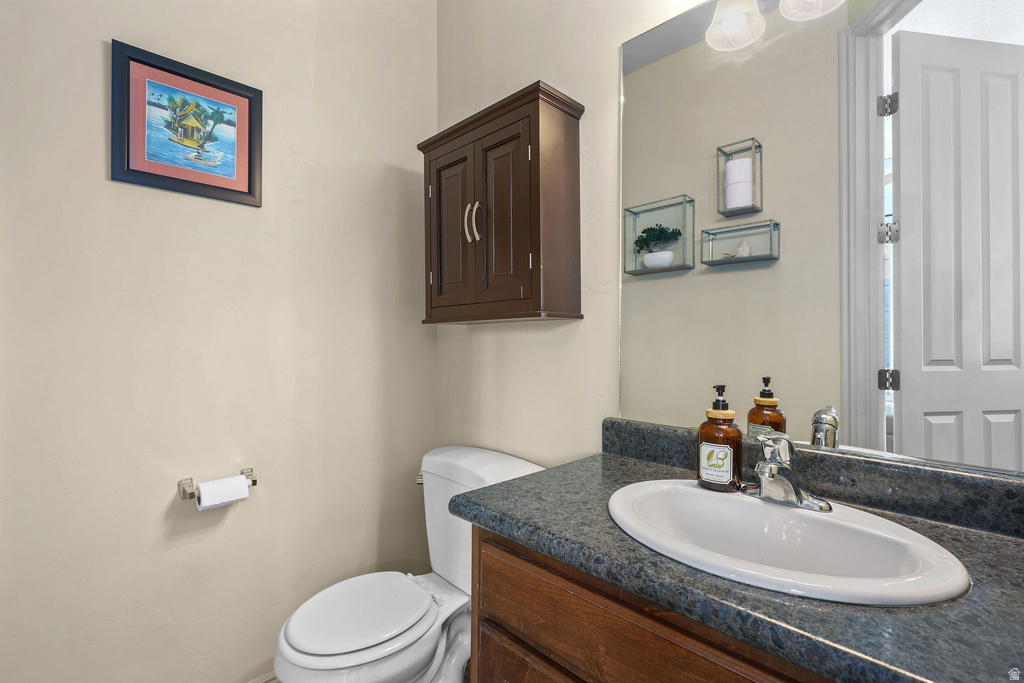 Vanity with an integrated oval sink and a dark, speckled countertop