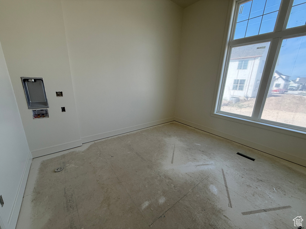 Bright room with a large multi-pane window and a laundry hookup station