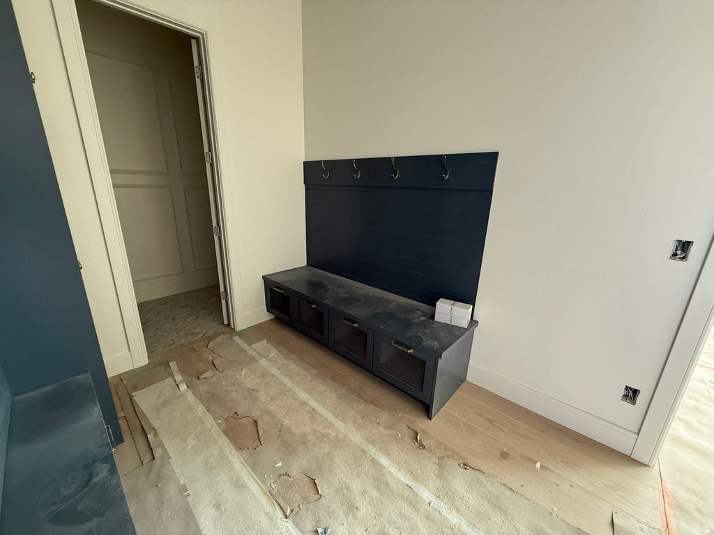Built-in mudroom bench with storage cabinets and coat hooks