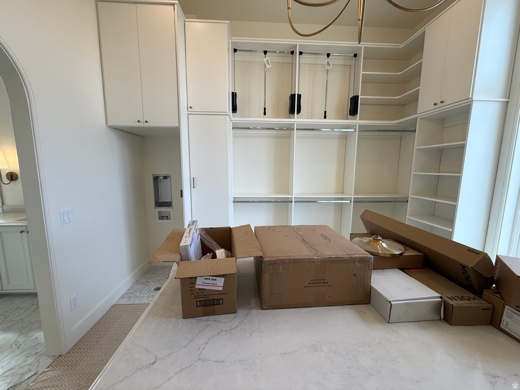 Built-in custom cabinetry, integrated shelving, and dedicated hanging storage