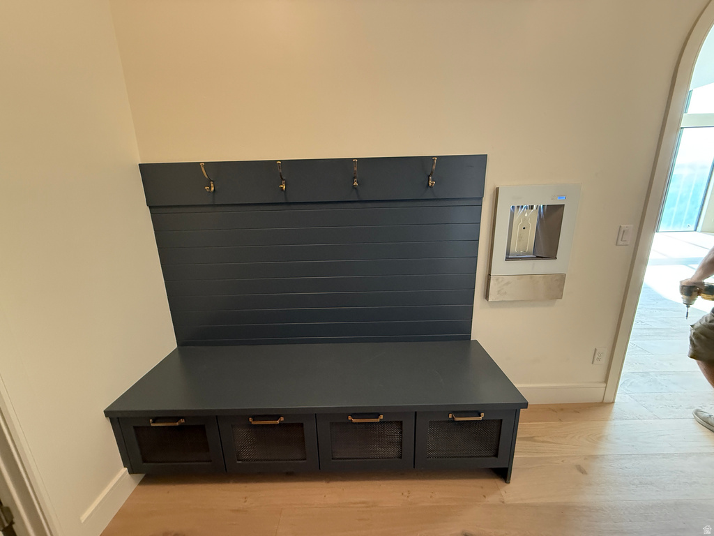 Built-in mudroom bench with paneled back, coat hooks, and storage cubbies