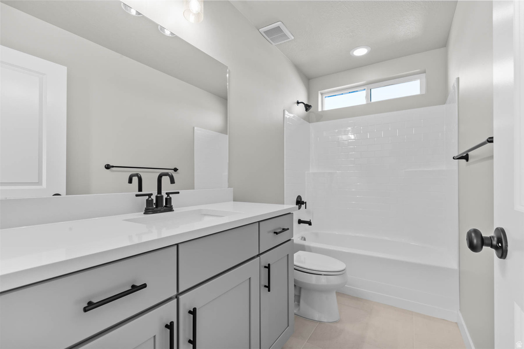 Contemporary bathroom featuring a light gray vanity with a white countertop and a rectangular undermount sink