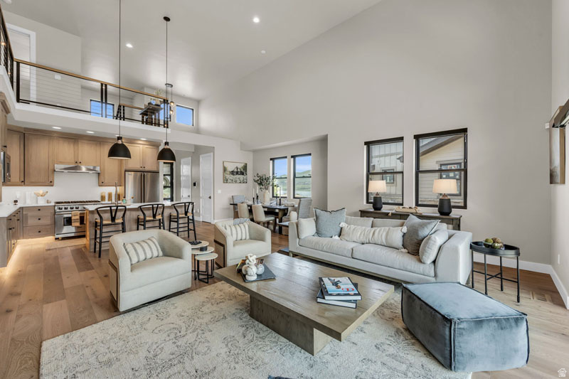 Open-concept living area featuring high vaulted ceilings and wood-finish flooring