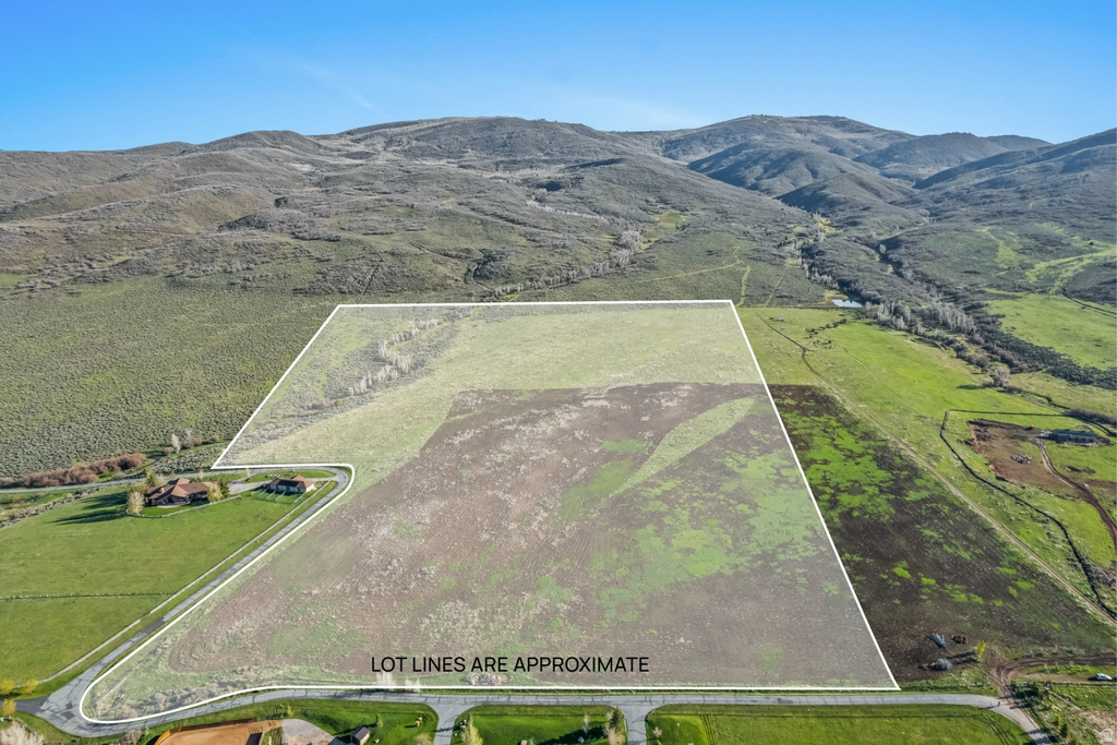 Expansive undeveloped parcel featuring varied terrain including open fields and a treed section