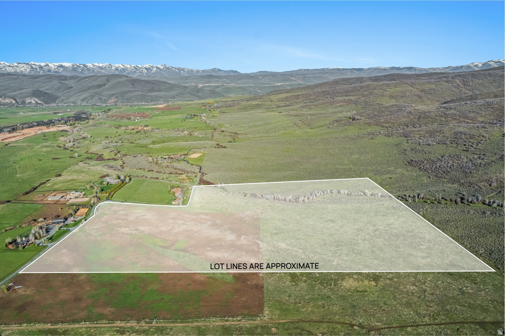 Expansive raw land parcel featuring varied terrain, including flat and sloped areas