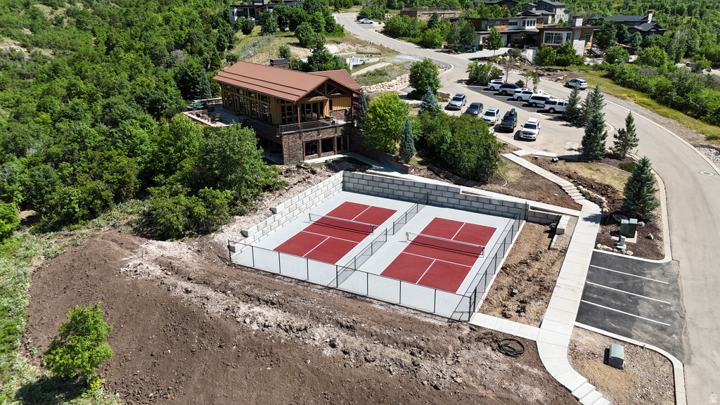 Two red hard-surface courts with white perimeter fencing