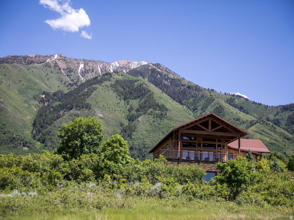 Rustic wood-clad residence set against a mountainous backdrop