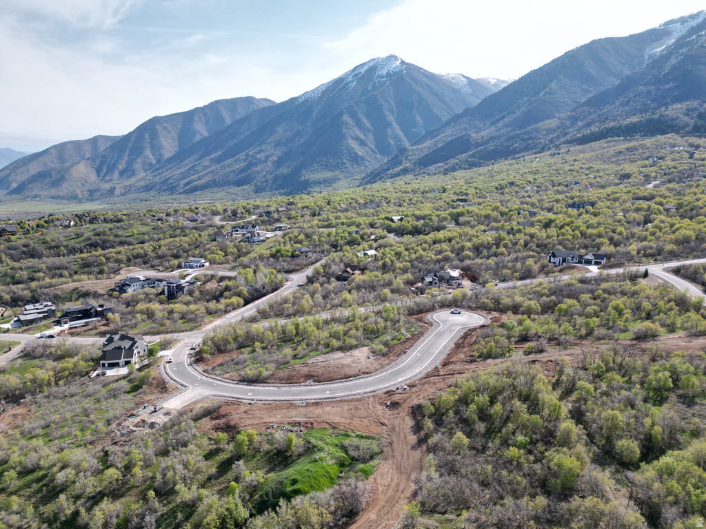 Expansive mountain setting featuring a paved road system and wooded terrain