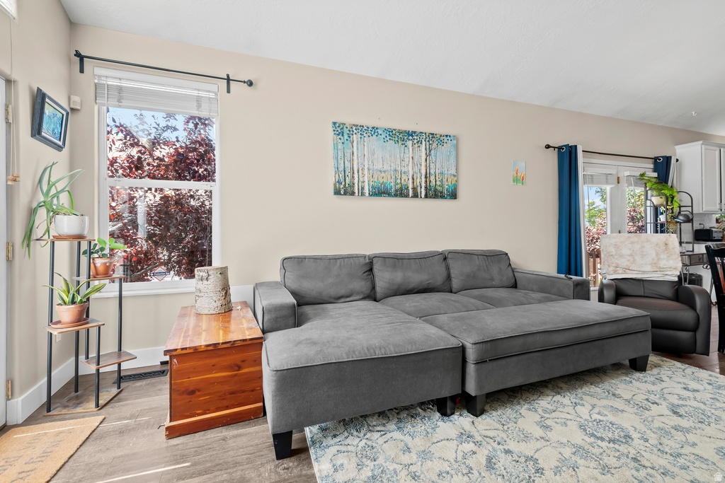 Living area featuring light-toned walls and wood-finish flooring