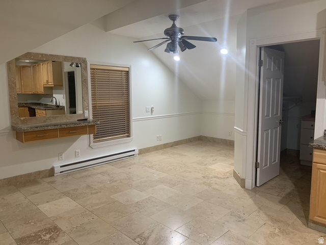 Spacious interior featuring large format tile flooring, a mounted mirror with a granite surround, and a ceiling fan with integrated lighting