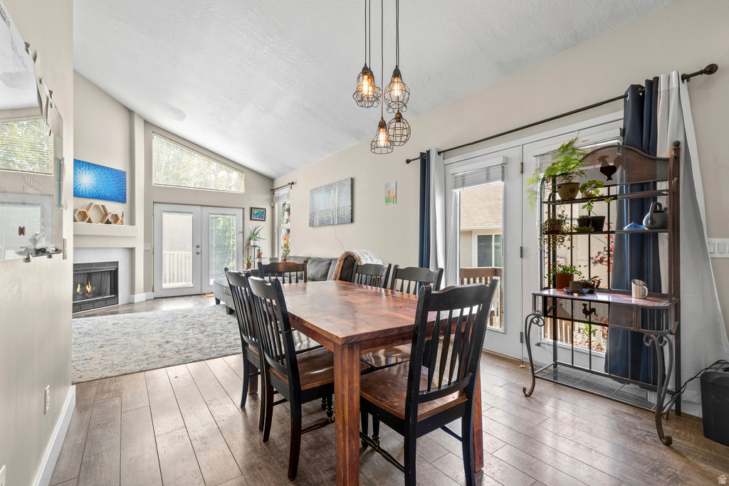 Open-concept living area with vaulted ceilings and wood-finish flooring