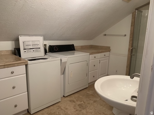 Laundry area featuring a top-load washing machine and a front-load dryer