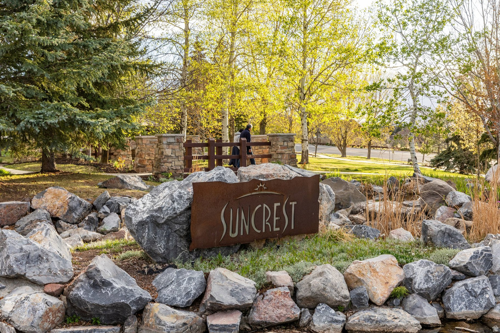 Stone and rock landscaping featuring a rust-finish metal "Suncrest" sign