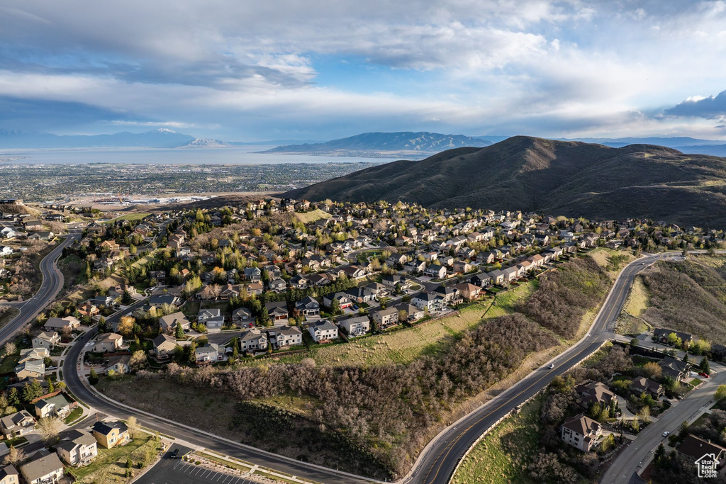 Residential development featuring hillside homes, established roads, and a mountainous backdrop