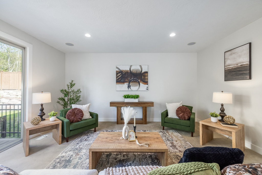 Living area featuring recessed lighting, a sliding glass door, and light neutral wall finishes