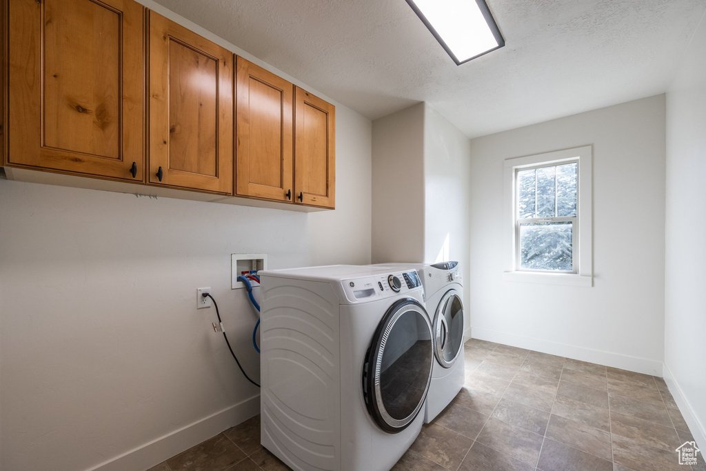 Laundry area featuring wood cabinetry, tiled flooring, a transom window, and a rectangular ceiling light fixture