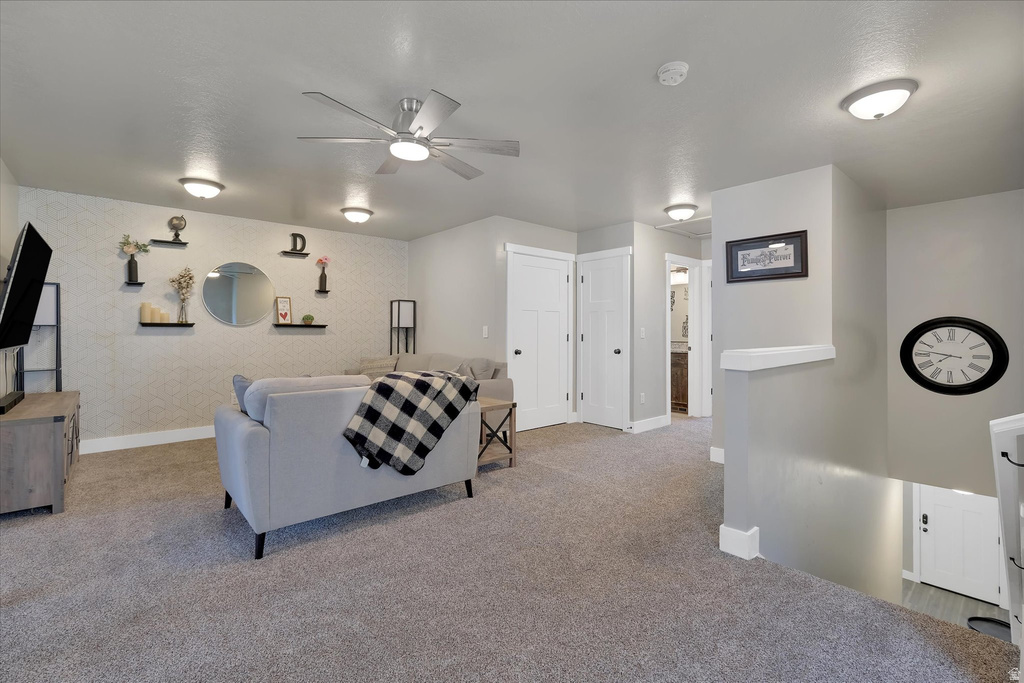 Spacious secondary living area featuring neutral carpeting and light gray wall tones