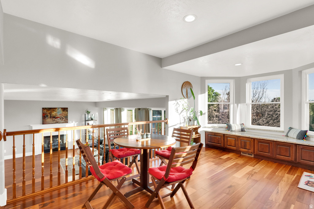Hardwood flooring throughout this bright upper-level loft space, featuring a built-in window seat with integrated storage