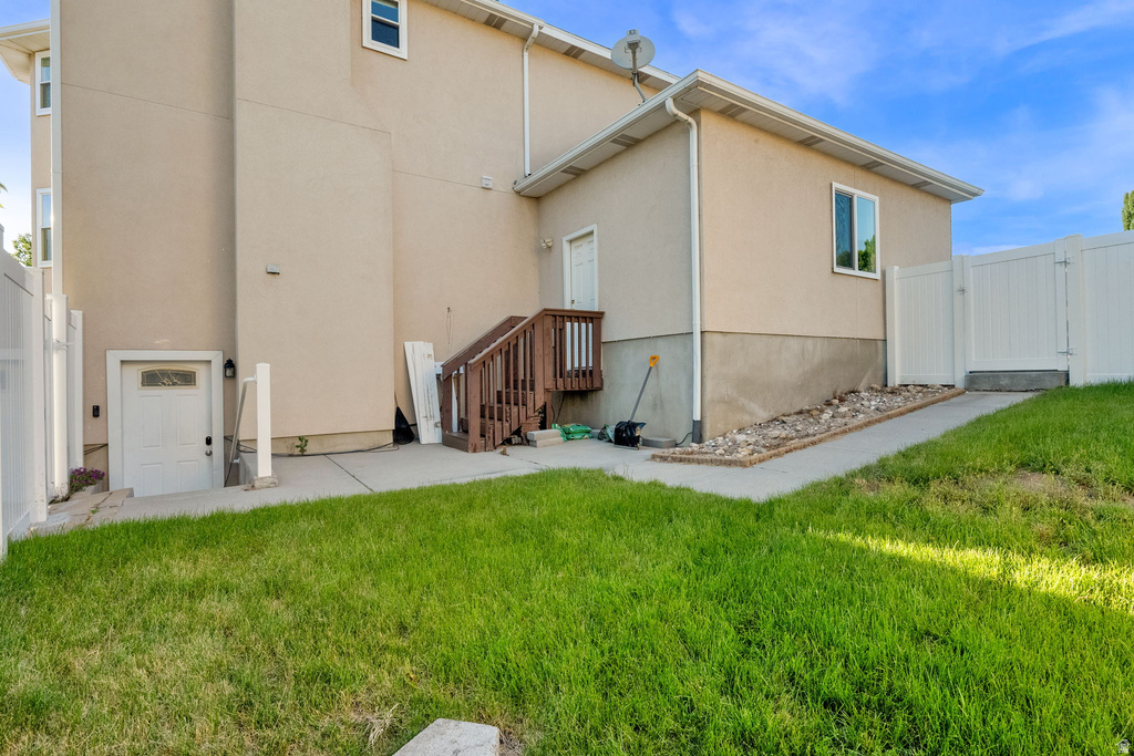 Exterior with stucco finish and a private side yard entrance