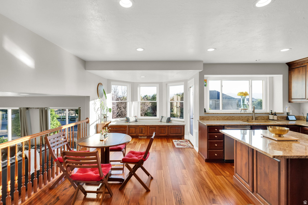 Bright kitchen and dining area featuring wood-finish flooring