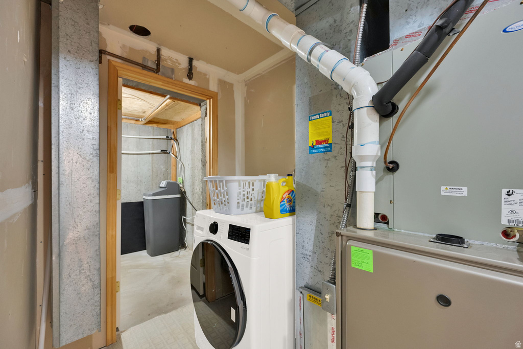Utility area featuring a furnace and laundry facilities