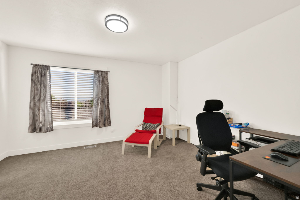 Carpeted room with a flush-mount ceiling light fixture, white walls, and a window with blinds