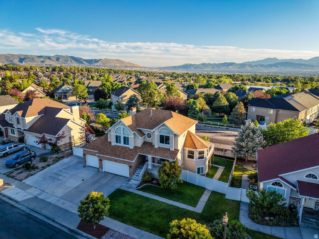 Traditional two-story residence with a multi-car garage, featuring a turret architectural element and a gabled roof