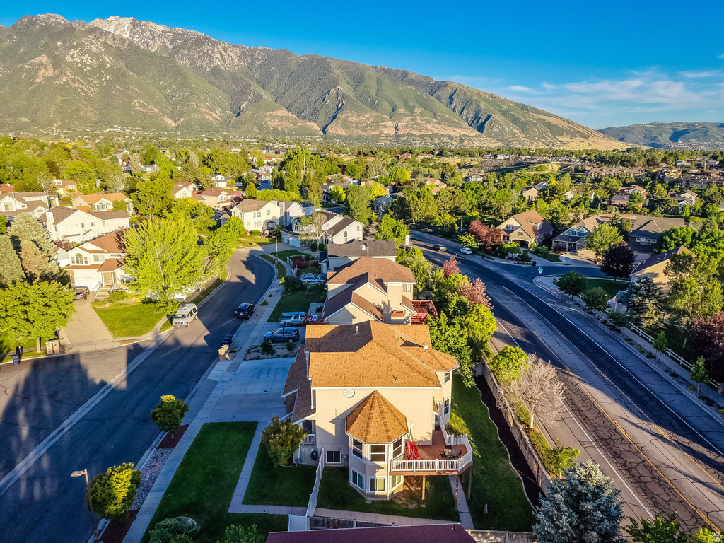 Aerial perspective of a neighborhood featuring a two-story residence with a turret-style architectural element