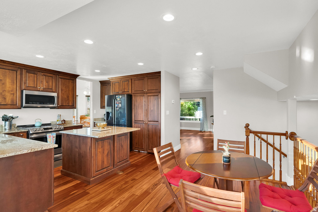 Kitchen featuring wood-finish flooring, recessed lighting, and rich wood cabinetry