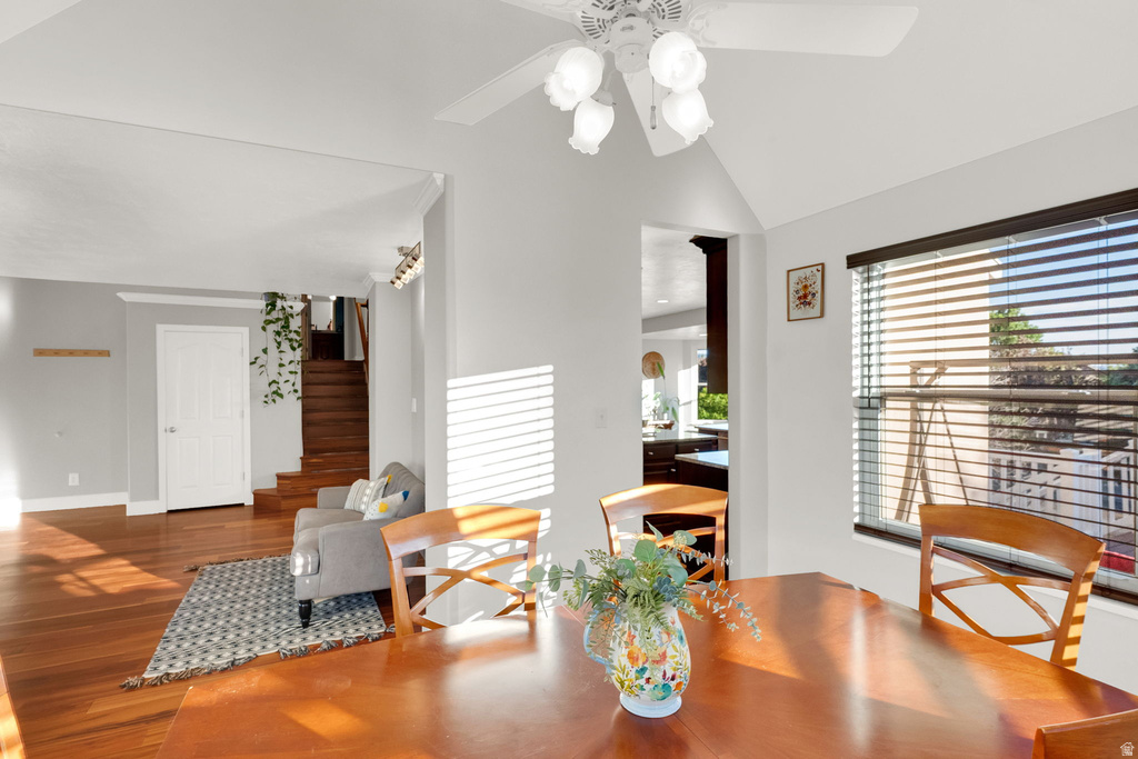Bright dining area featuring a wood-finish table, white ceiling fan, and window with blinds
