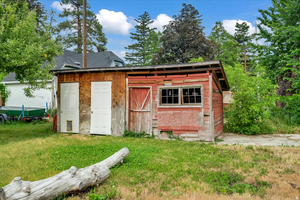 Freestanding shed structure featuring multiple access doors and exterior windows