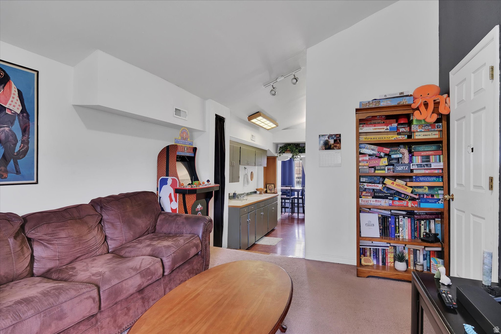 Open concept living space featuring neutral wall tones and carpeted flooring