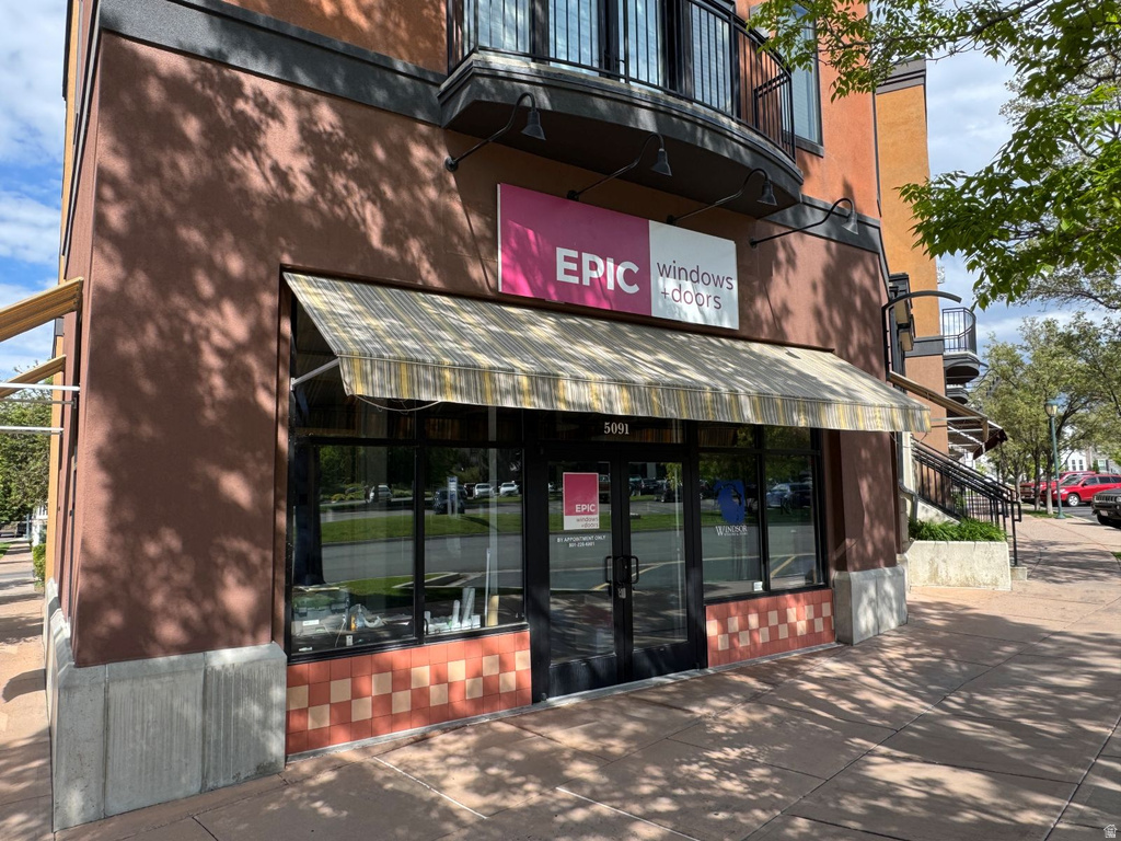 Commercial storefront with a striped awning and large display windows