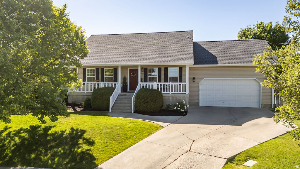 Ranch-style exterior with beige siding and a dark shingle roof